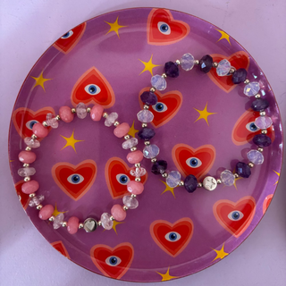 Decorative plate with heart and star patterns on a pink background